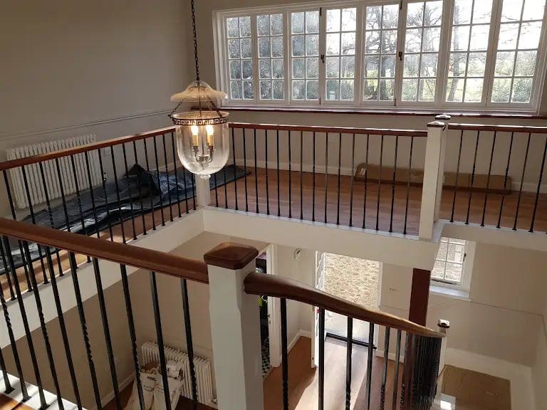 Freshly decorated galleried landing with lantern window and dark timber balustrade